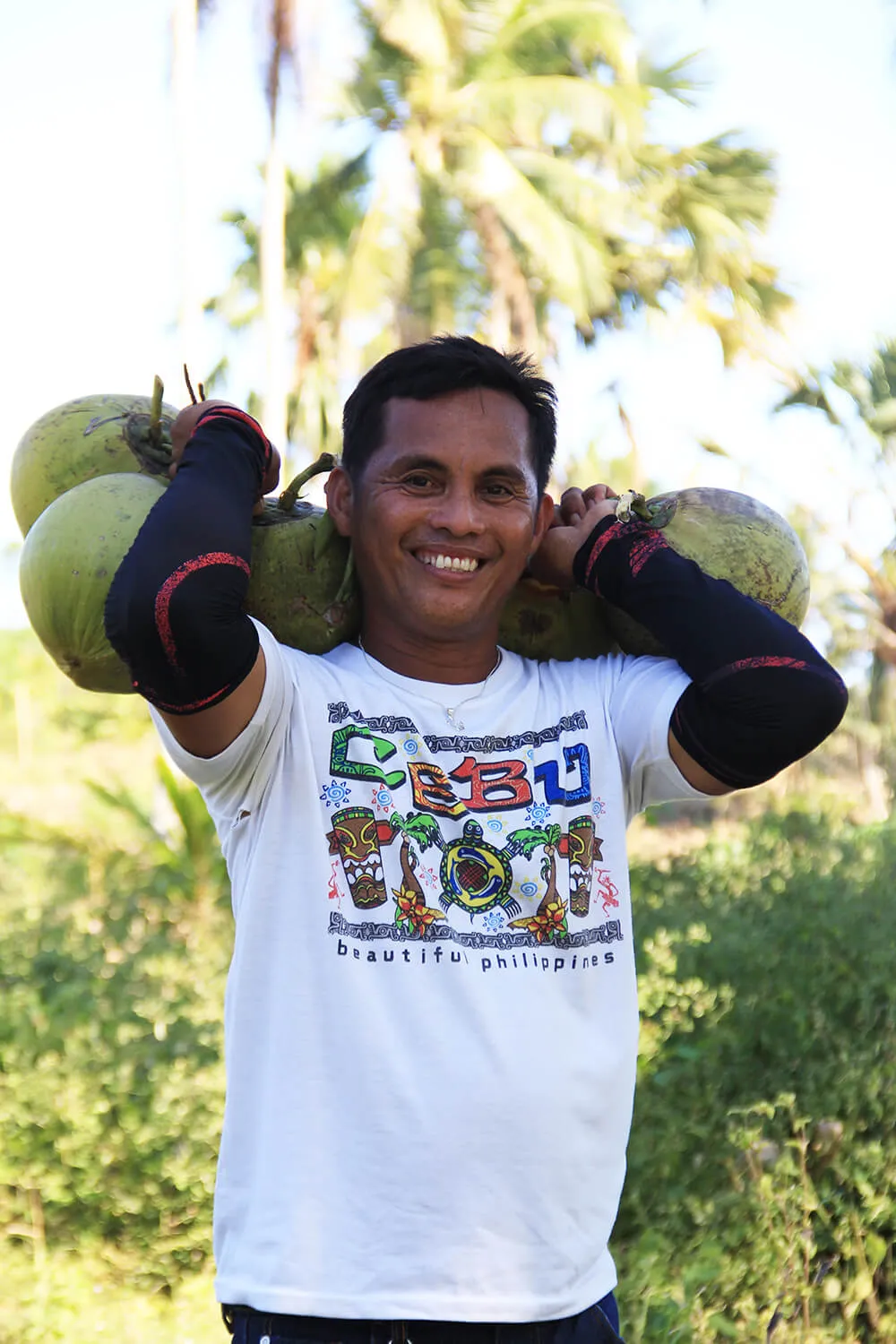 man holding coconuts